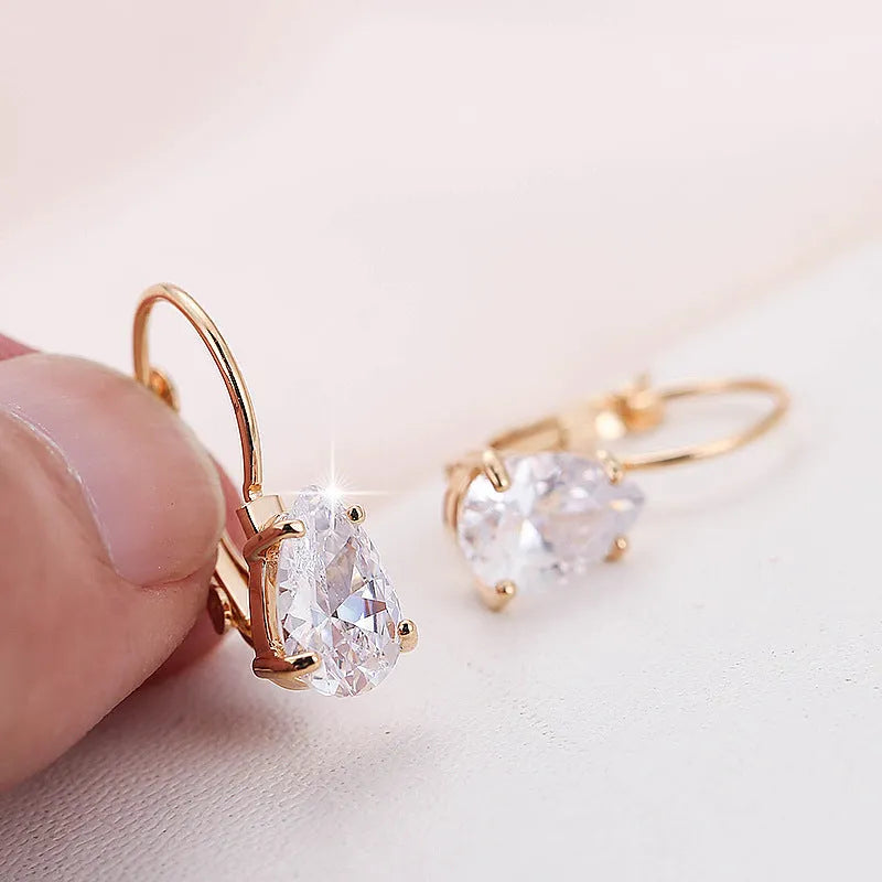 Drop-shaped copper fashion earrings with gemstone inlays in gold or platinum colour finishes
