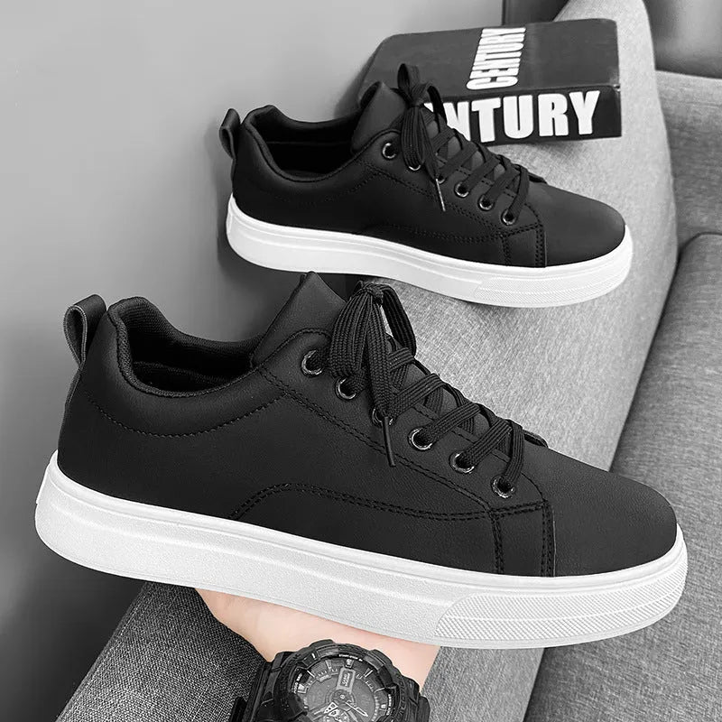 Men's low-top white and black Korean-style casual sneakers with round toe and rubber sole.