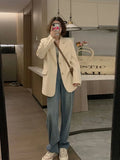 Men's beige Korean-style casual suit jacket with long sleeves and a chest pocket on a hanger.