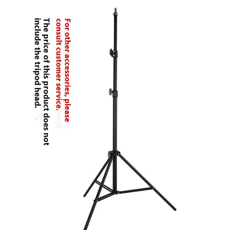 Tall black floor tripod stand holding a mobile phone extended to its full height on a wooden floor.