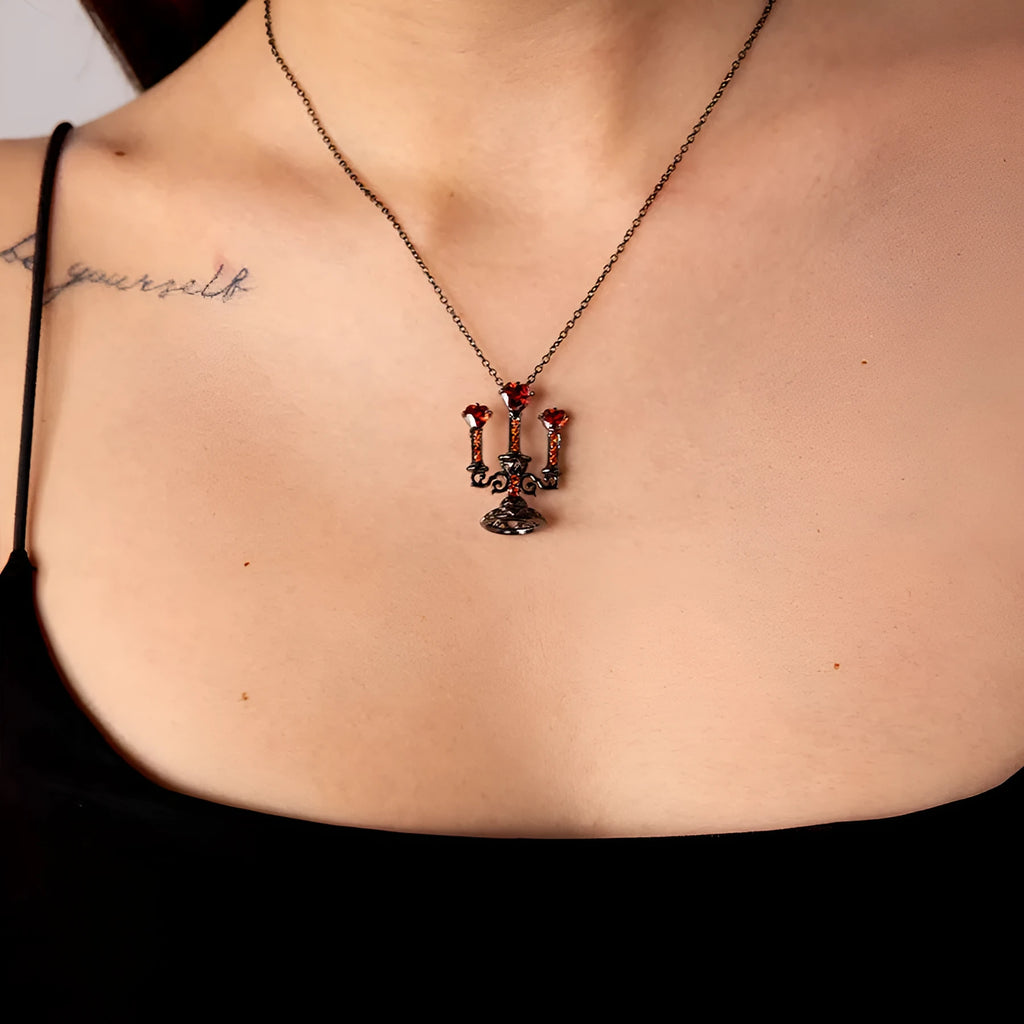 Women's retro candlestick pendant necklace on a gothic cross chain.