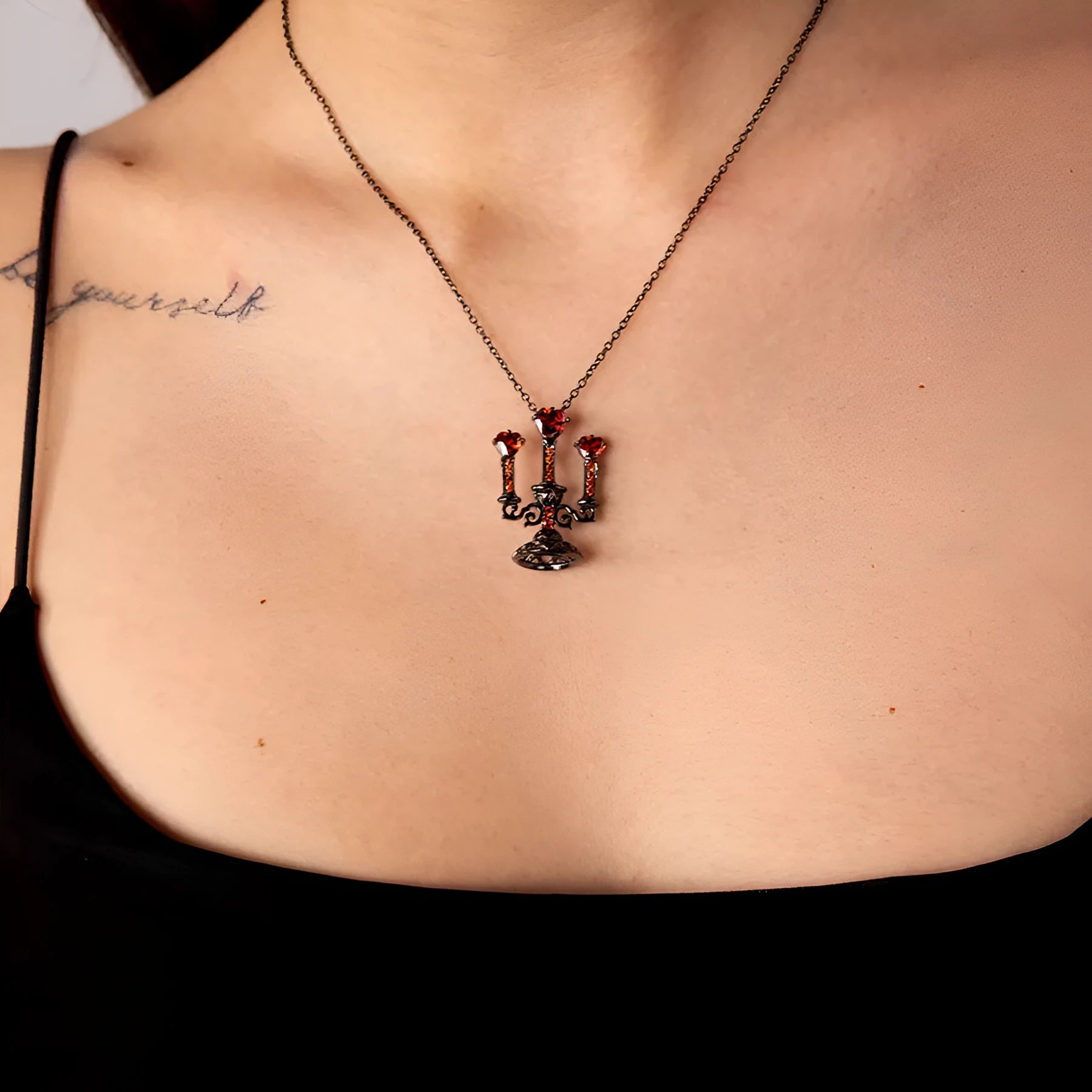 Women's retro candlestick pendant necklace on a gothic cross chain.