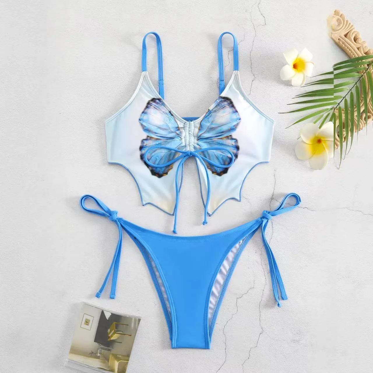 Purple women's bikini suit with bow detail and split design on a mannequin.