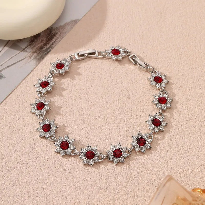 Adjustable zinc alloy bracelet with electroplated flower-shaped links in gold and silver colour options with gemstone accents.