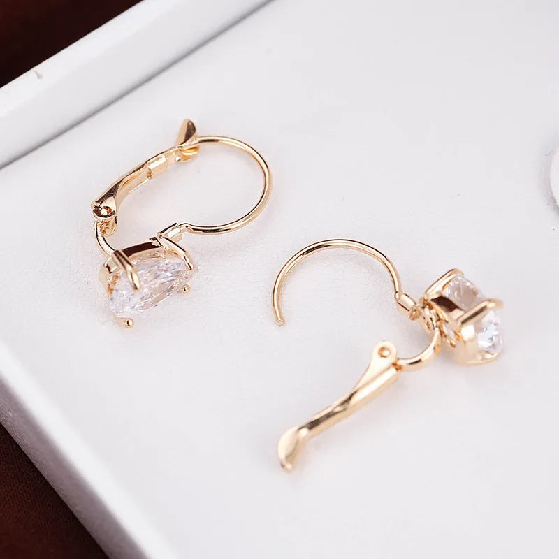 Drop-shaped copper fashion earrings with gemstone inlays in gold or platinum colour finishes