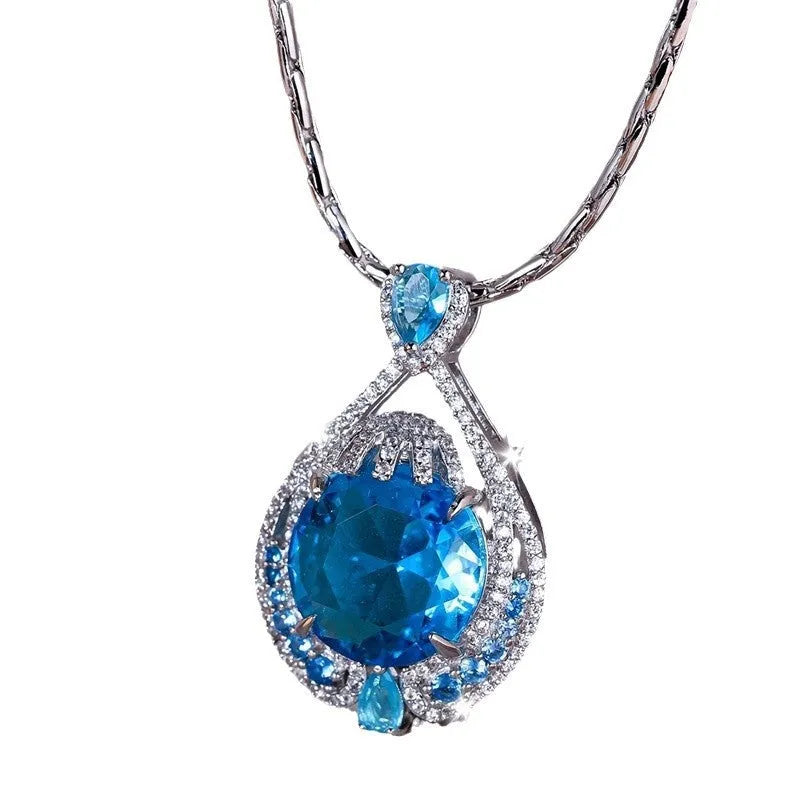 Blue geometric crystal pendant necklace on a water wave chain for women.