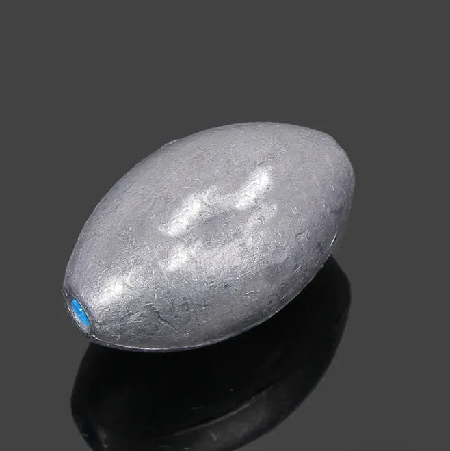 Olive-coloured rugby-shaped fishing sinker with a textured scale surface and plastic core, shown in various weights.