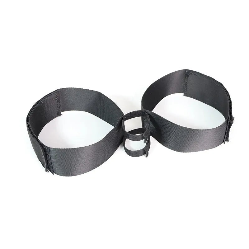Black knitted belt strap accessory for adult sex toy appliances on plain background