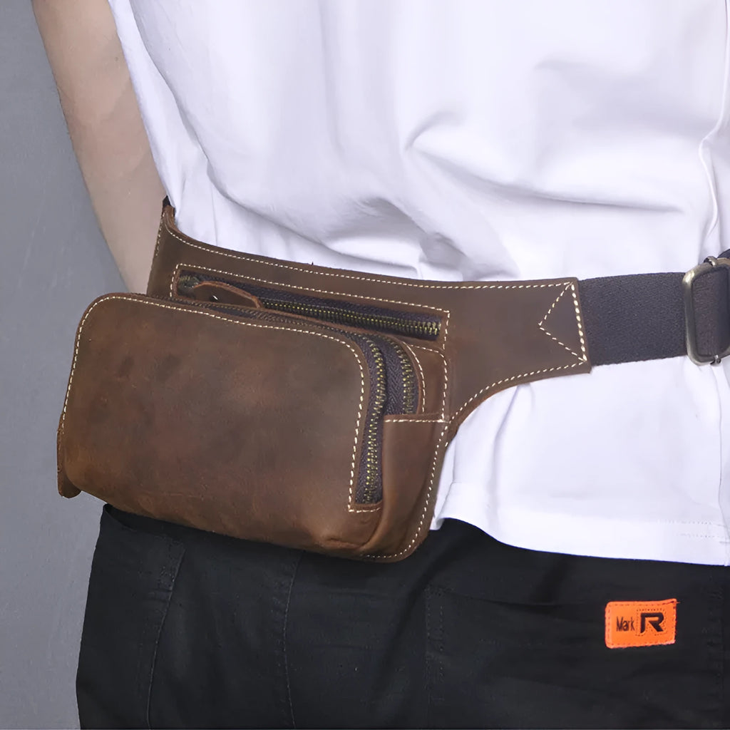 Brown cowhide men's sports waist bag with pull closure showing internal phone compartment