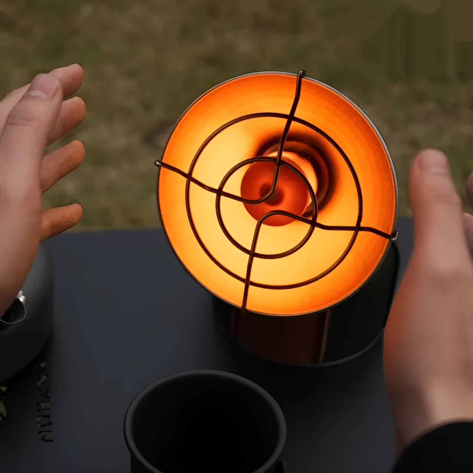 Black and orange portable camping heating stove with automatic press ignition system