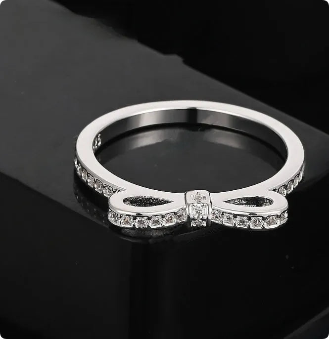 Silver couple's ring with bow design and zircon crystal rhinestones on sterling silver band