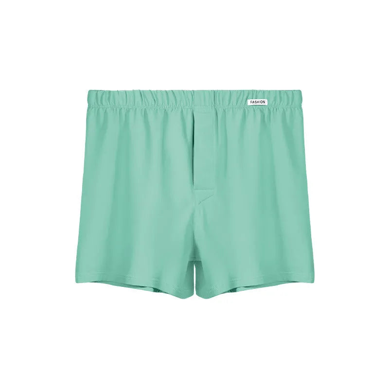 Men's loose-fitting cotton boxer shorts in a solid colour, shown in a mid waist design.