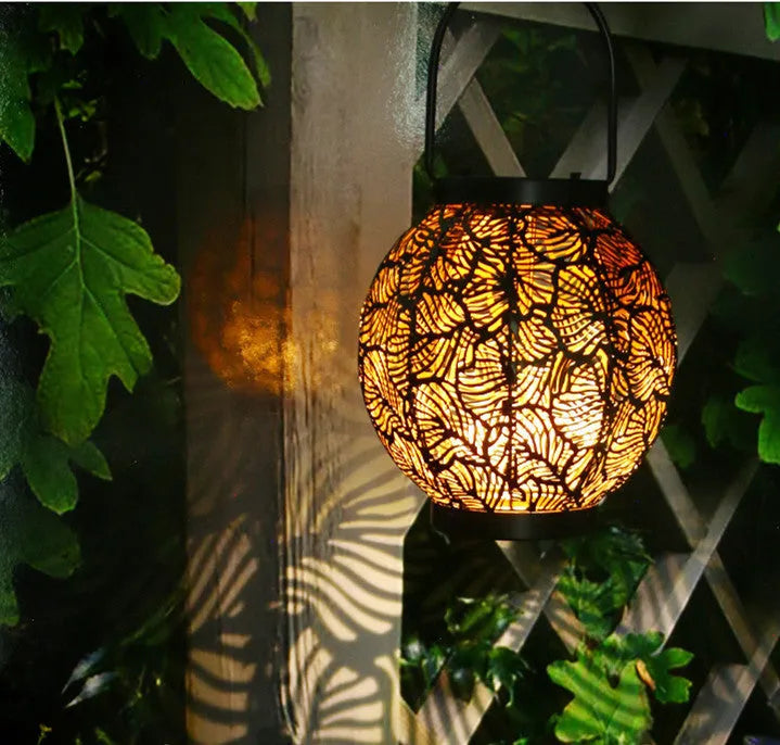 Solar-powered decorative iron courtyard lamp with hollow design for outdoor garden use