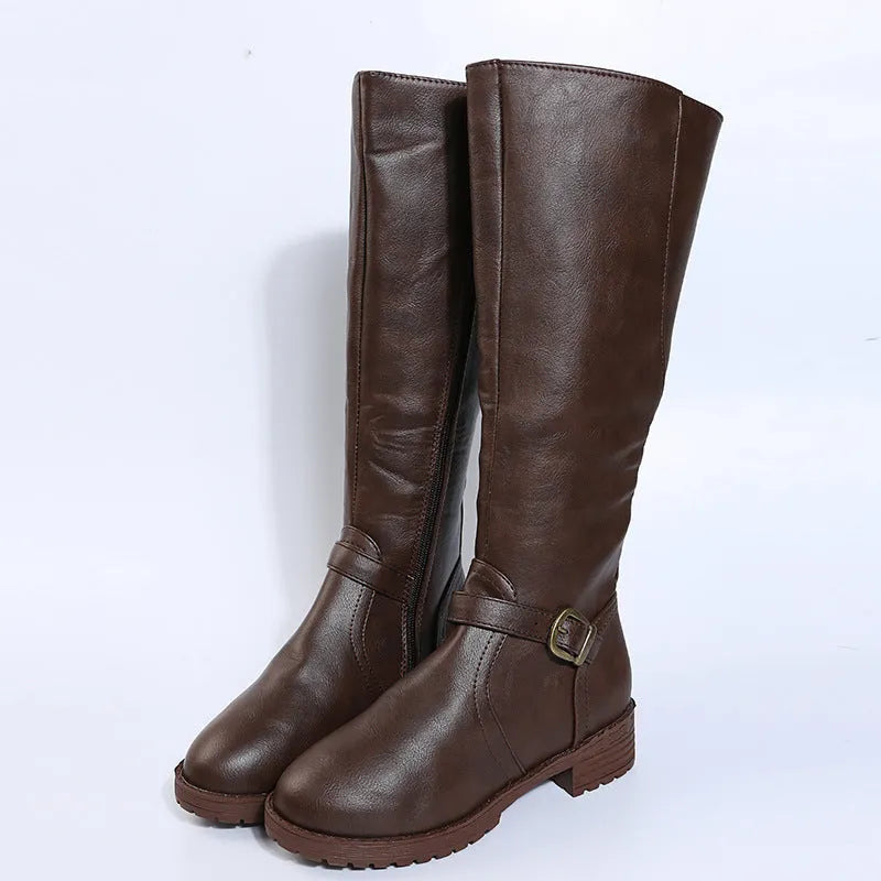 Women's black knight boots with a square heel, high shaft, and a front belt buckle fastening.