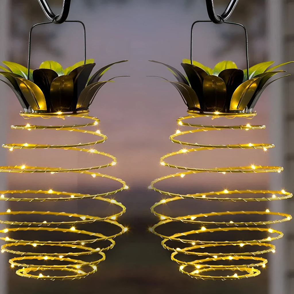 Outdoor waterproof green pineapple solar path light with 20 warm white LEDs and metal frame on a garden table