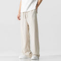 Men's beige loose-fit linen-style bamboo fibre trousers with a cropped leg and drawstring waist laid flat.
