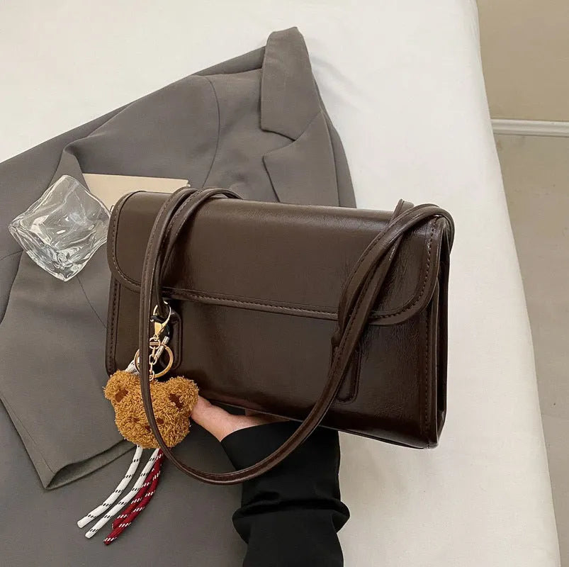 Women's brown PU leather square shoulder bag with decorative pendant and double strap