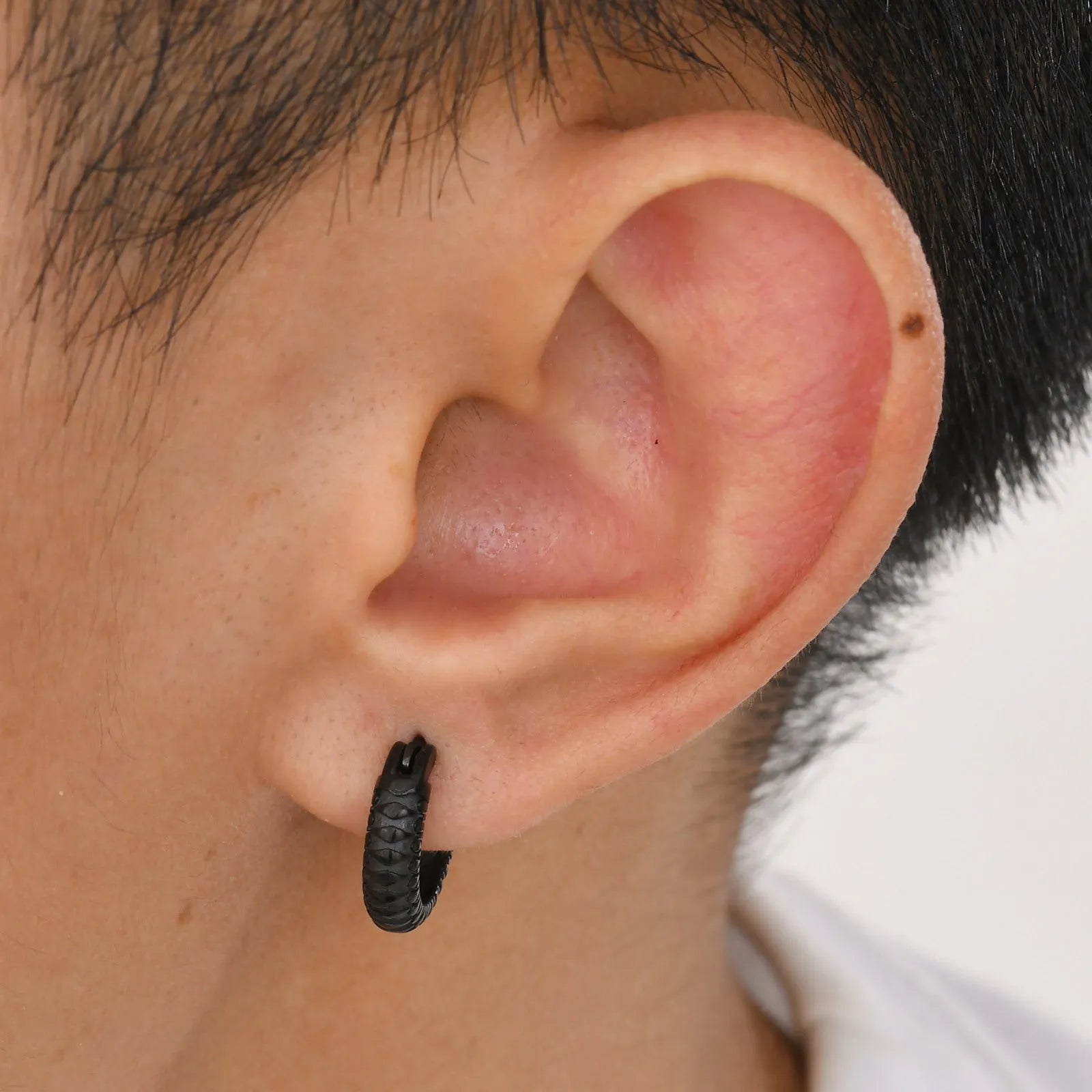 Stainless steel men's earrings with snake pattern design in black and gold colour options