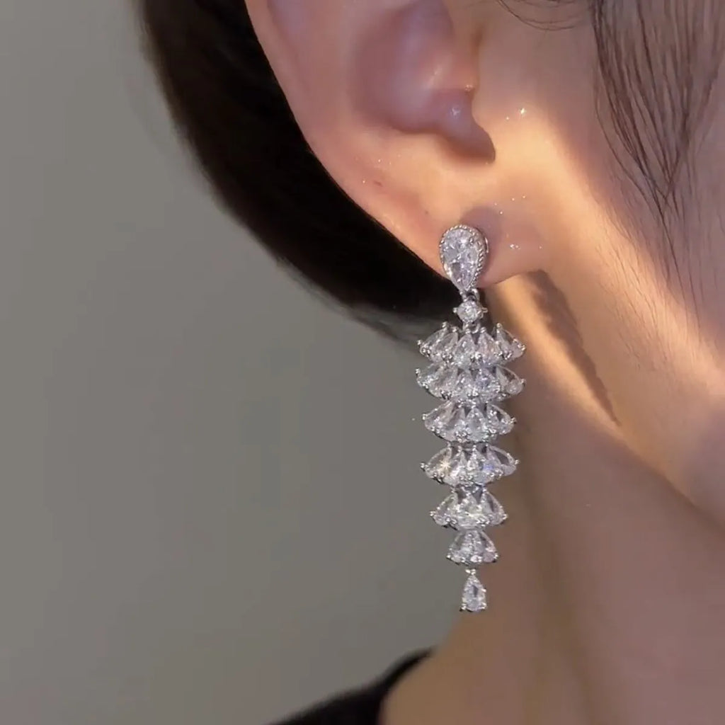 Women's silver pagoda Christmas tree drop earrings with a dangling zircon star on copper studs.