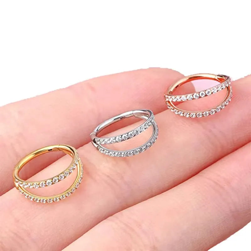 G23 titanium alloy lip ring and nose ring in gold and steel colour on a white background.