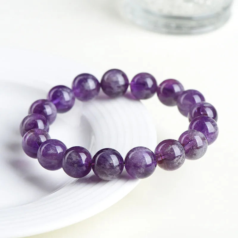 Natural purple Snow Mountain feather amethyst crystal bracelet with scattered geometry beads and Ruyi element.