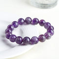 Natural purple Snow Mountain feather amethyst crystal bracelet with scattered geometry beads and Ruyi element.