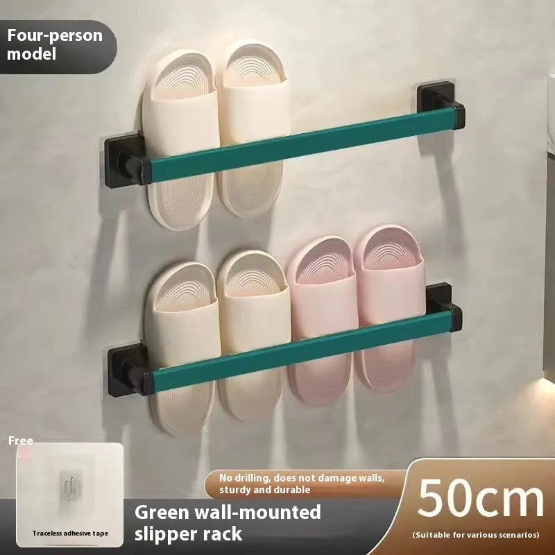 Black wall-mounted bathroom slipper rack with a small integrated seat, showing adhesive backing for punch-free installation.