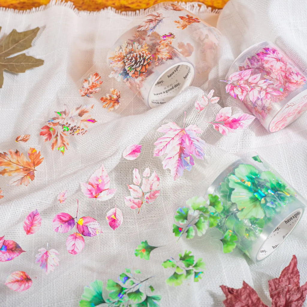 Roll of nature-themed decorative stickers showing ginkgo leaves, maple leaves, and blue fallen leaves designs
