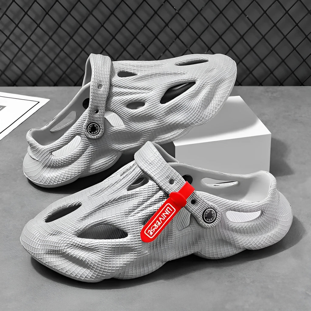 Pair of grey closed-toe EVA coconut slippers on a solid background, showing the frosted finish and cap style.