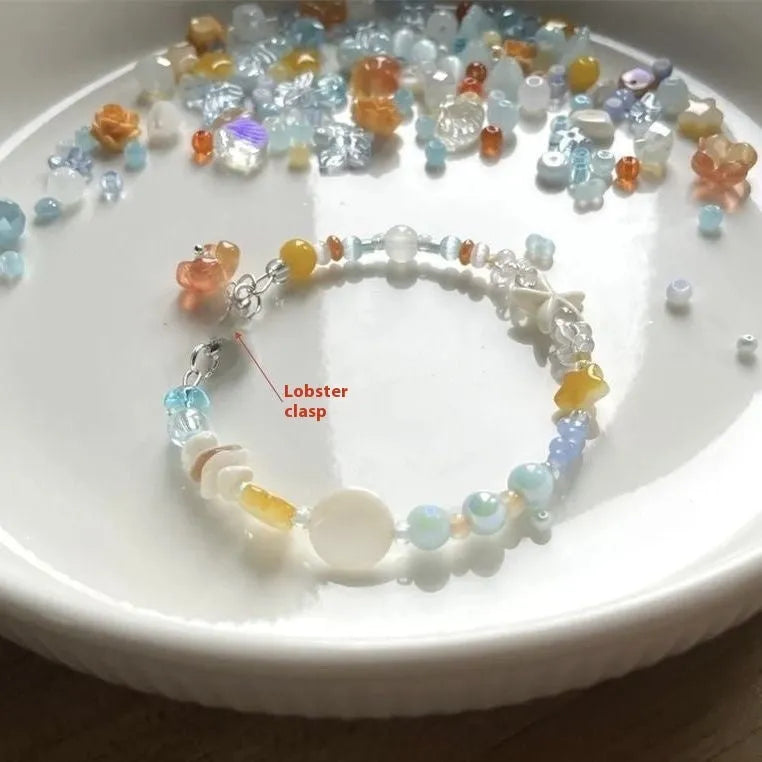 Orange alloy bracelet for women with a diamond shape and round decorative elements on a summer seaside theme.