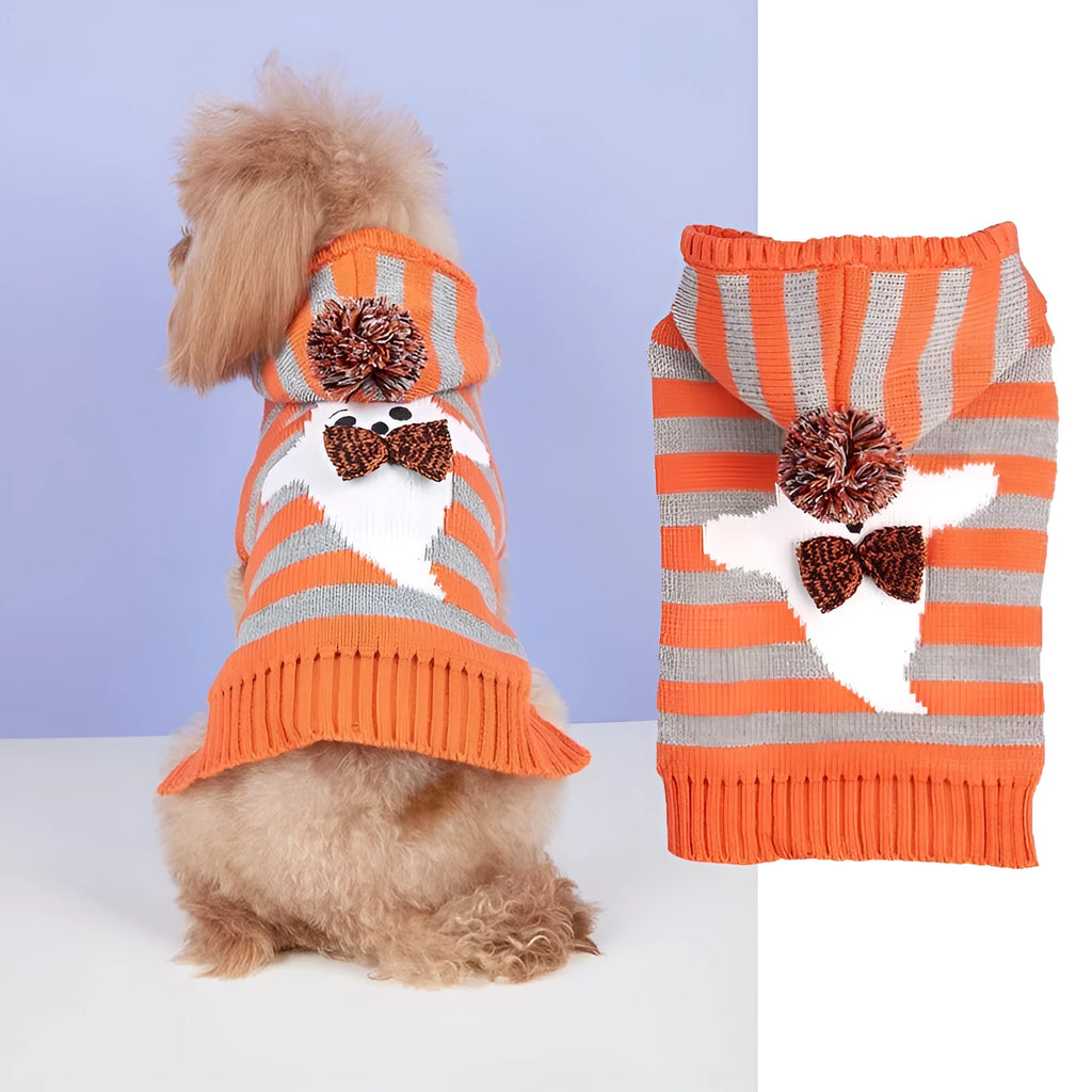 Orange knitted dog sweater with striped pattern, fur ball trim, and a hood for Halloween.