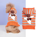 Orange knitted dog sweater with striped pattern, fur ball trim, and a hood for Halloween.