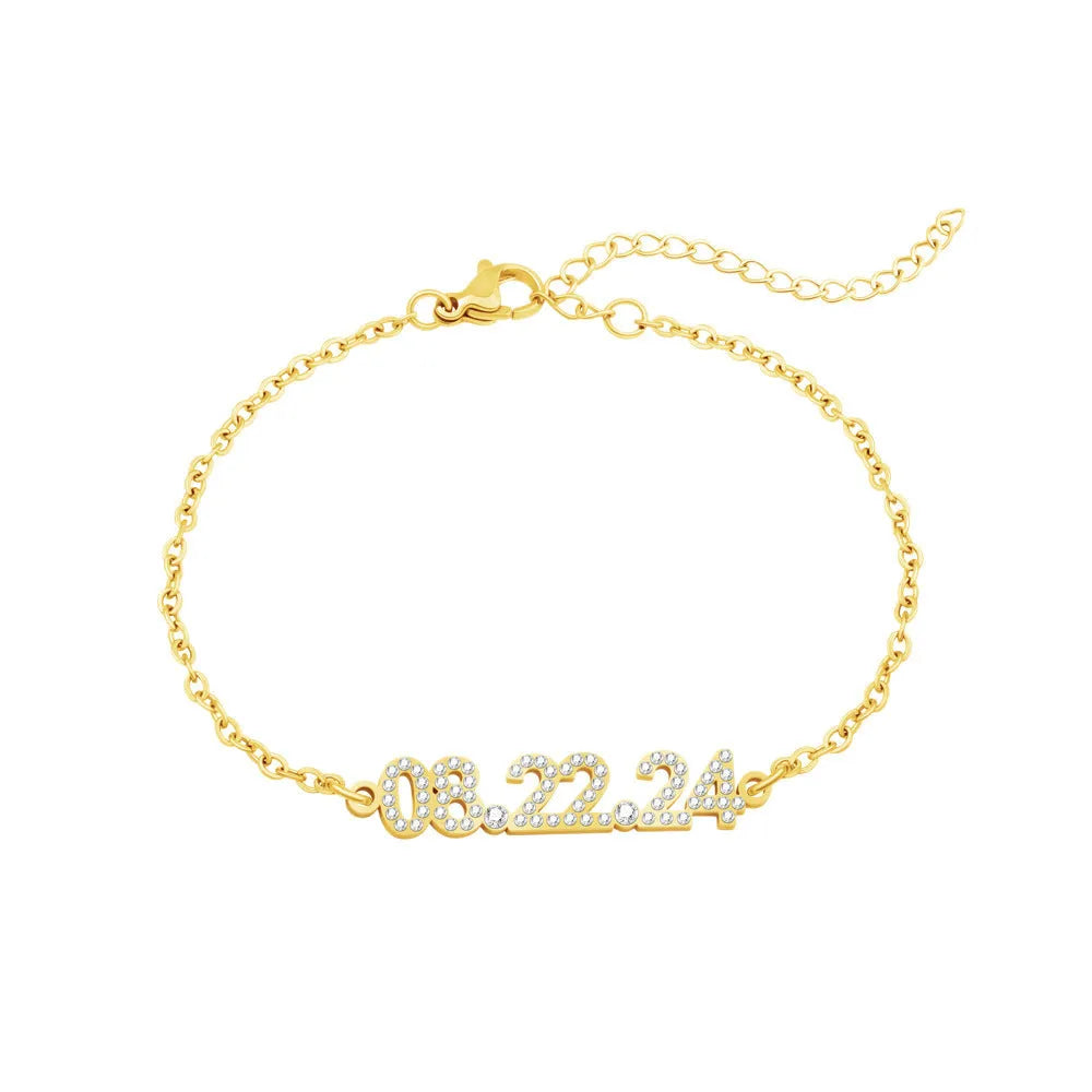 Stainless steel bracelet or necklace with diamond accents around digital numerals in gold, rose gold, or steel colour.