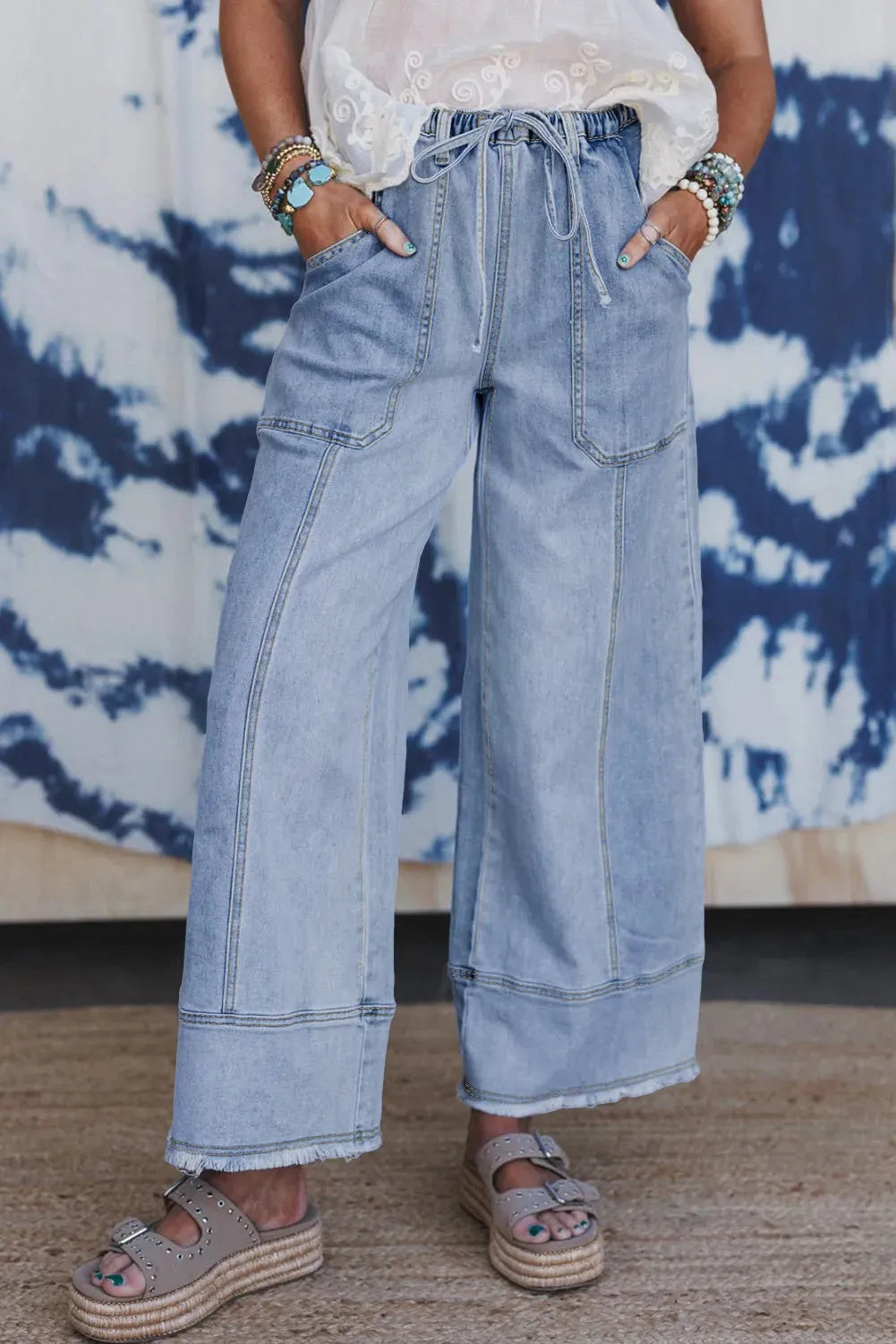 Beau blue wide-leg denim trousers with drawstring waist and raw hem detailing