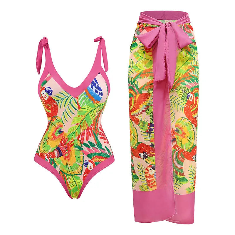 Pink floral retro one-piece swimsuit for women with V-neck and attached skirt on a hanger.