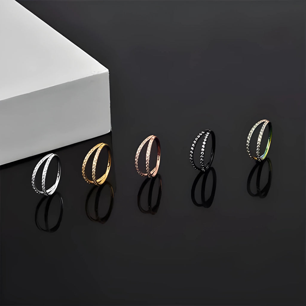 G23 titanium alloy lip ring and nose ring in gold and steel colour on a white background.