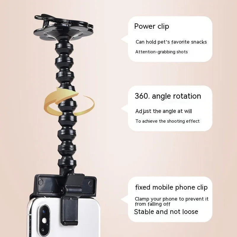Black pet photography clip with rotating treat holder attached to mobile phone