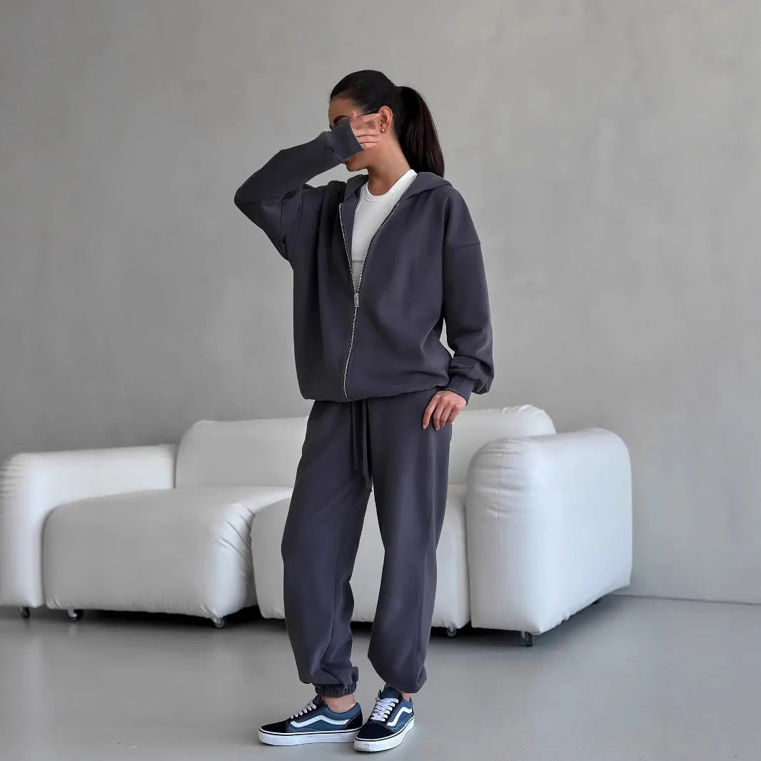 Women's loose fit polyester two-piece set with long-sleeved coat and trousers in a solid colour.