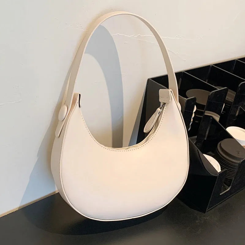 Women's retro dumpling-shaped PU shoulder bag in cream yellow with sandwich pocket