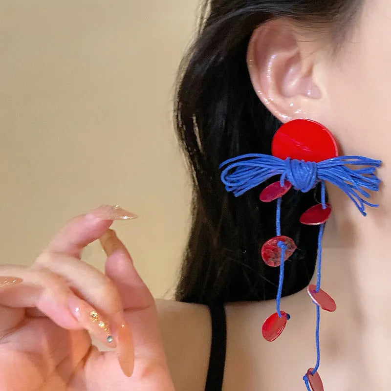 Women's geometric fabric earrings with blue resin flower detailing and silver needle colour