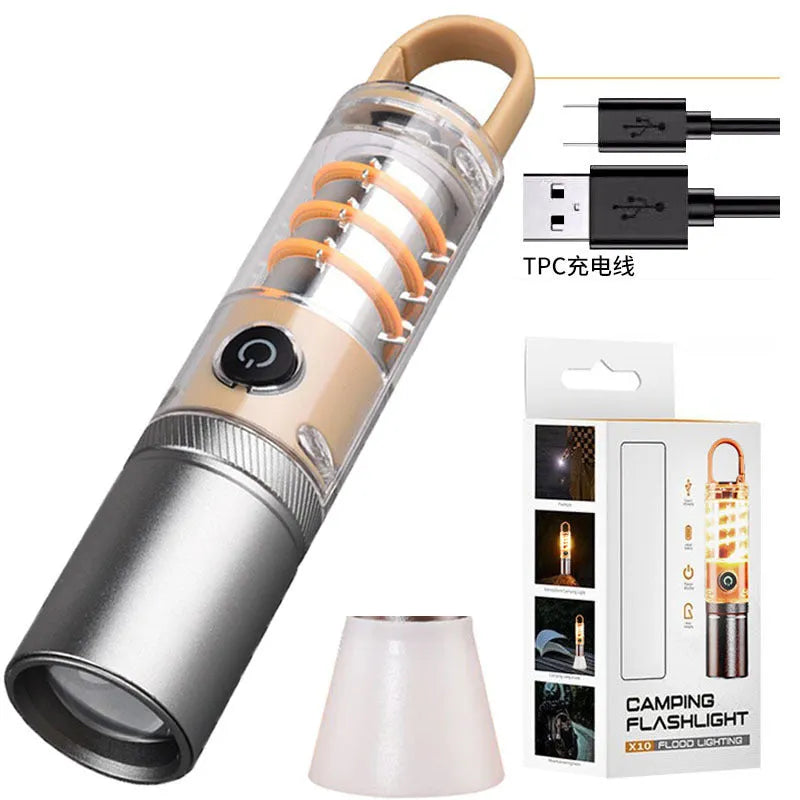 Orange and beige coloured LED torch with keychain loop, showing dual-light lens and USB port.