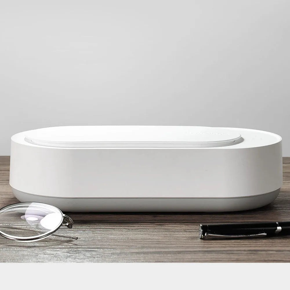 White portable ultrasonic cleaning machine with stainless steel tank for jewellery and glasses.
