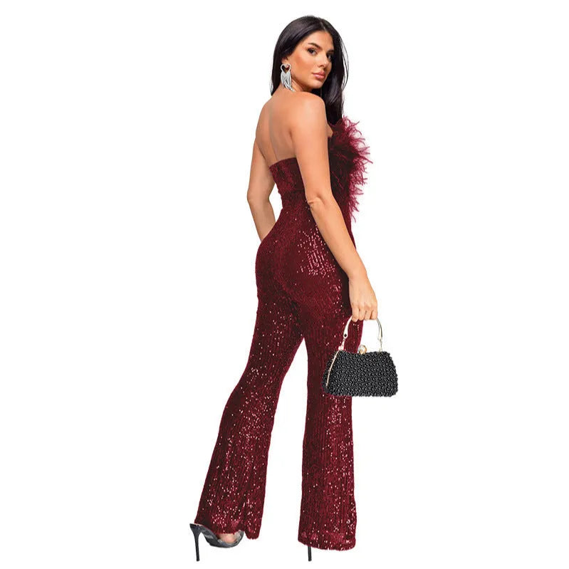 Women's black sleeveless backless jumpsuit with flared legs and sequin collar detail, laid flat.
