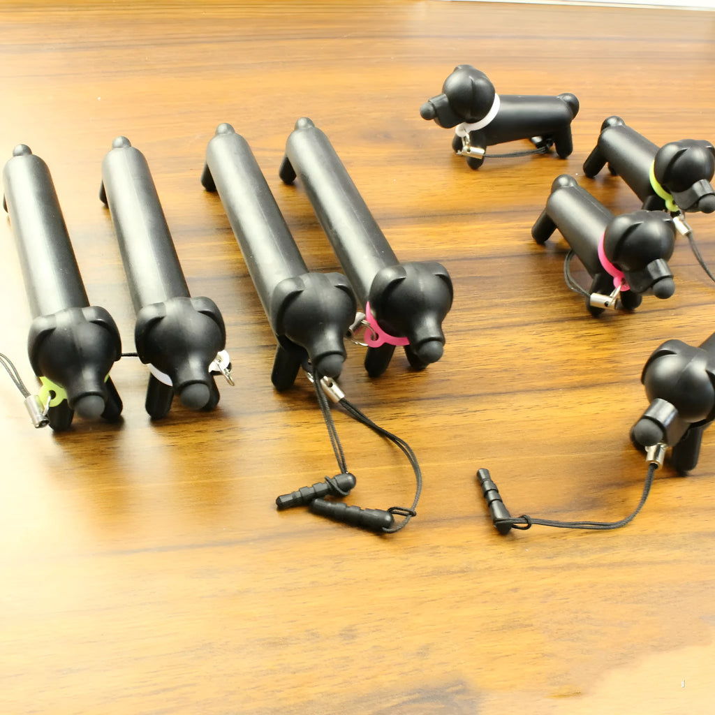 Black dog-shaped touch screen stylus with conductive construction shown next to its carry pouch