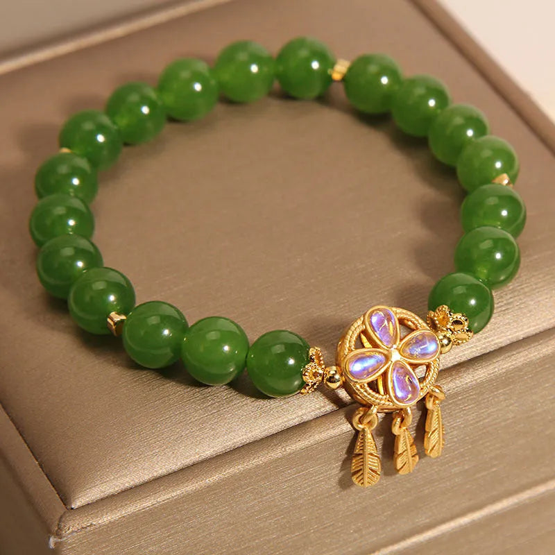 Green Jasper Crystal four-leaf clover dreamcatcher pendant on a women's bracelet.