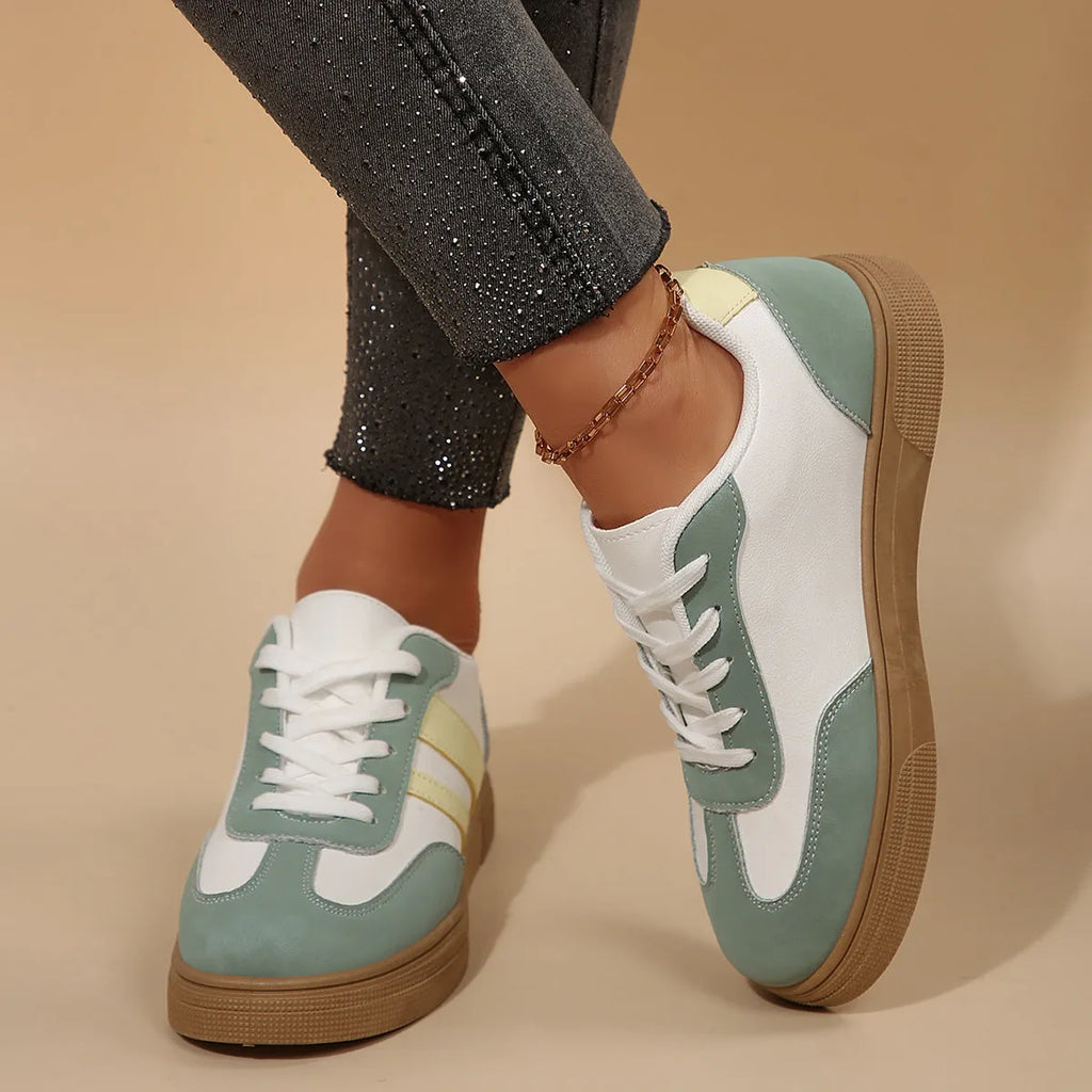 Women's green retro sports shoes with white cross straps, low top, flat rubber sole, and round toe.