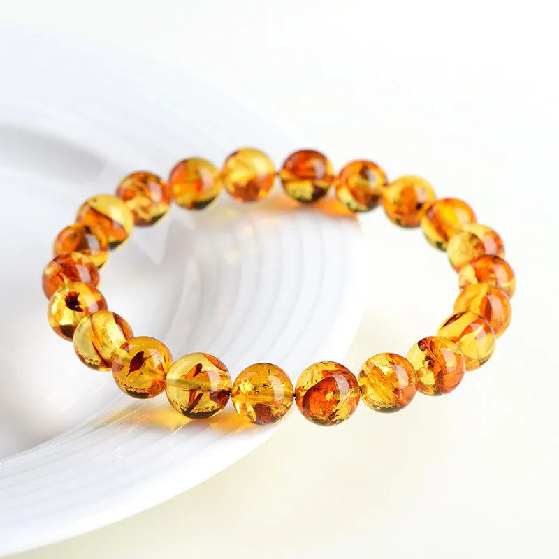 Natural yellow piebald amber bracelet with flower spot patterning in three bead size options
