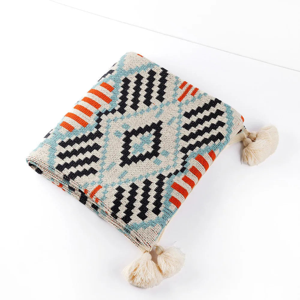Acrylic sofa cover blanket with tassel trim in beige and orange colour.
