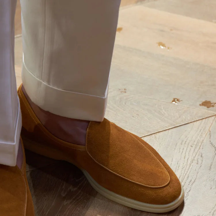 Men's brown genuine leather British handmade loafers on a white background.