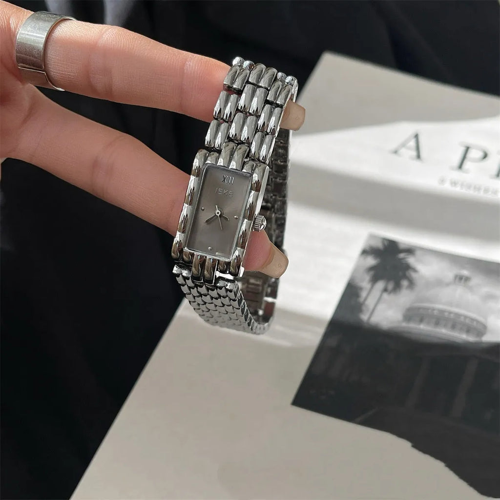 Women's bracelet watch with 15mm dial, spiral crown, and stainless steel strap in gold or silver finish